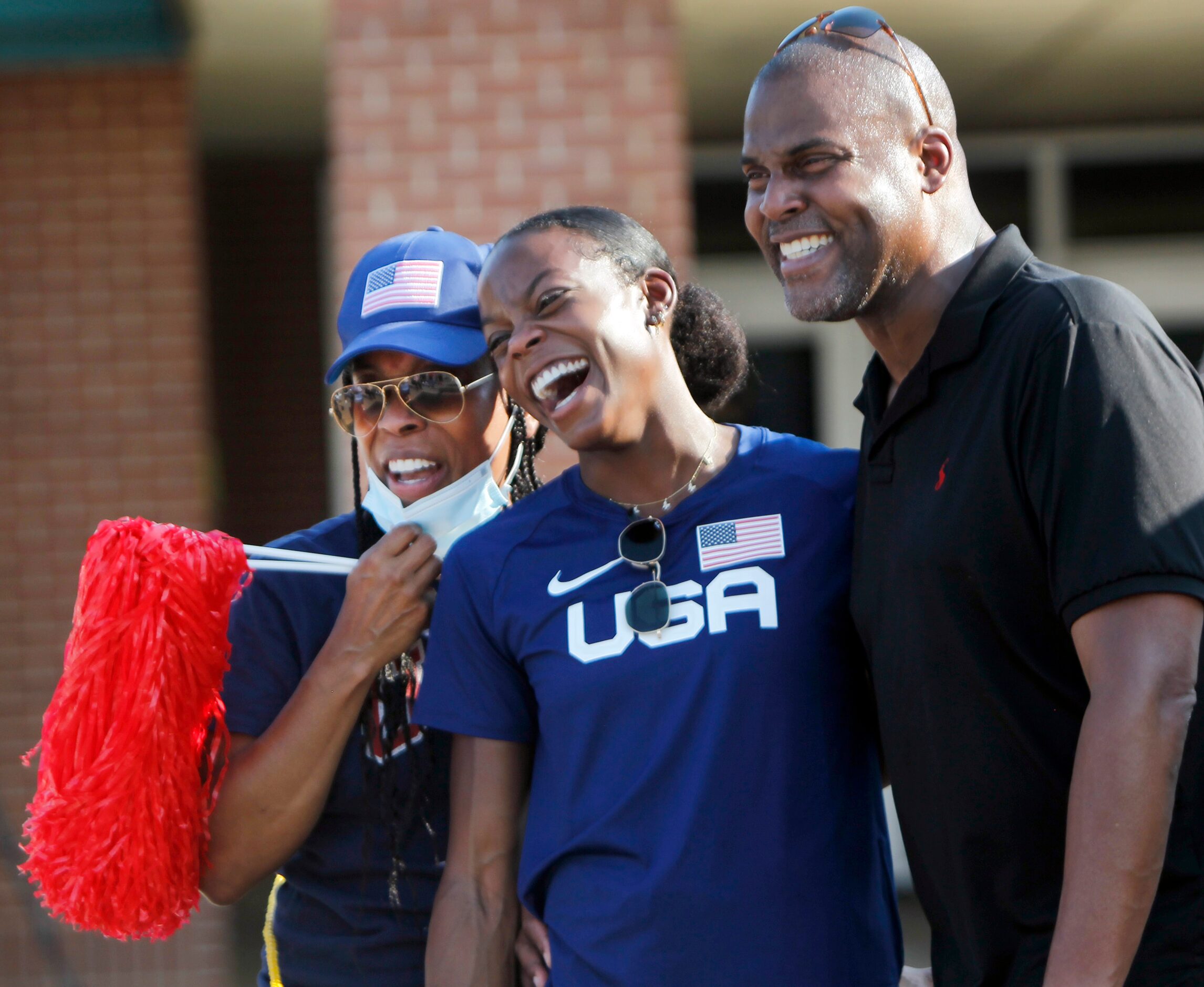 Jasmine Moore poses for a family photo with her two biggest cheerleaders, her parents Earl...