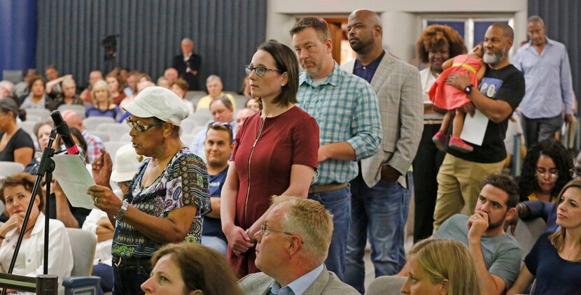 Anna Hill, president of the Dolphin Heights Neighborhood Association, at the microphone, and...