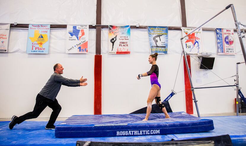 U.S. Gold Gymnastics coach Bobby Dombrowski runs to congratulate Hannah Ewing, 18, on her...