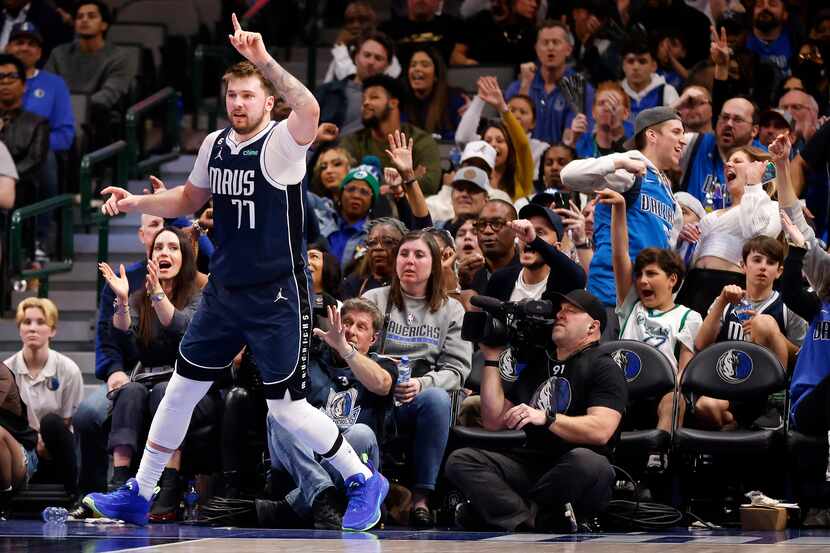 Dallas Mavericks guard Luka Doncic (77) raises his finger after a made layup against the...