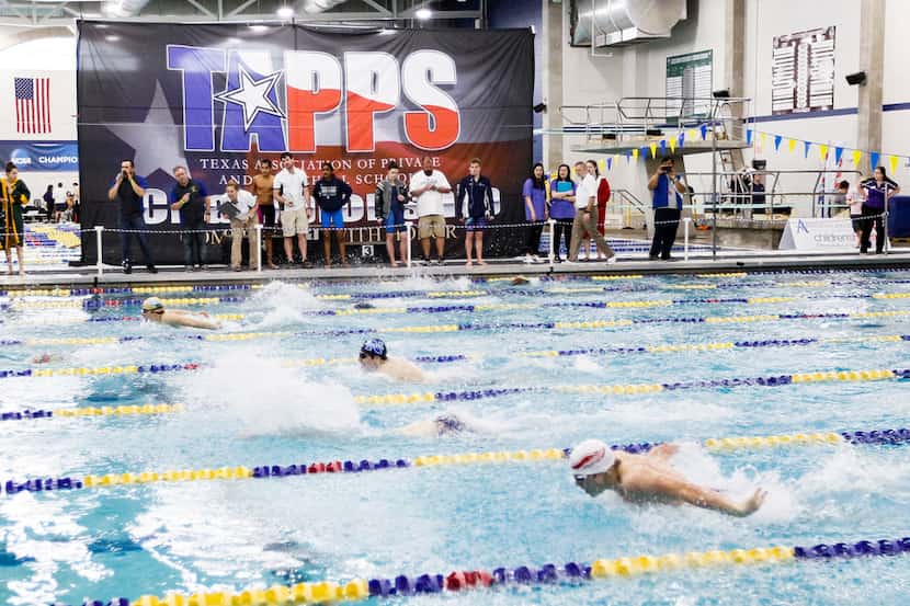 Swimmers compete during the TAPPS Division I state swim meet at the Mansfield ISD Natatorium...