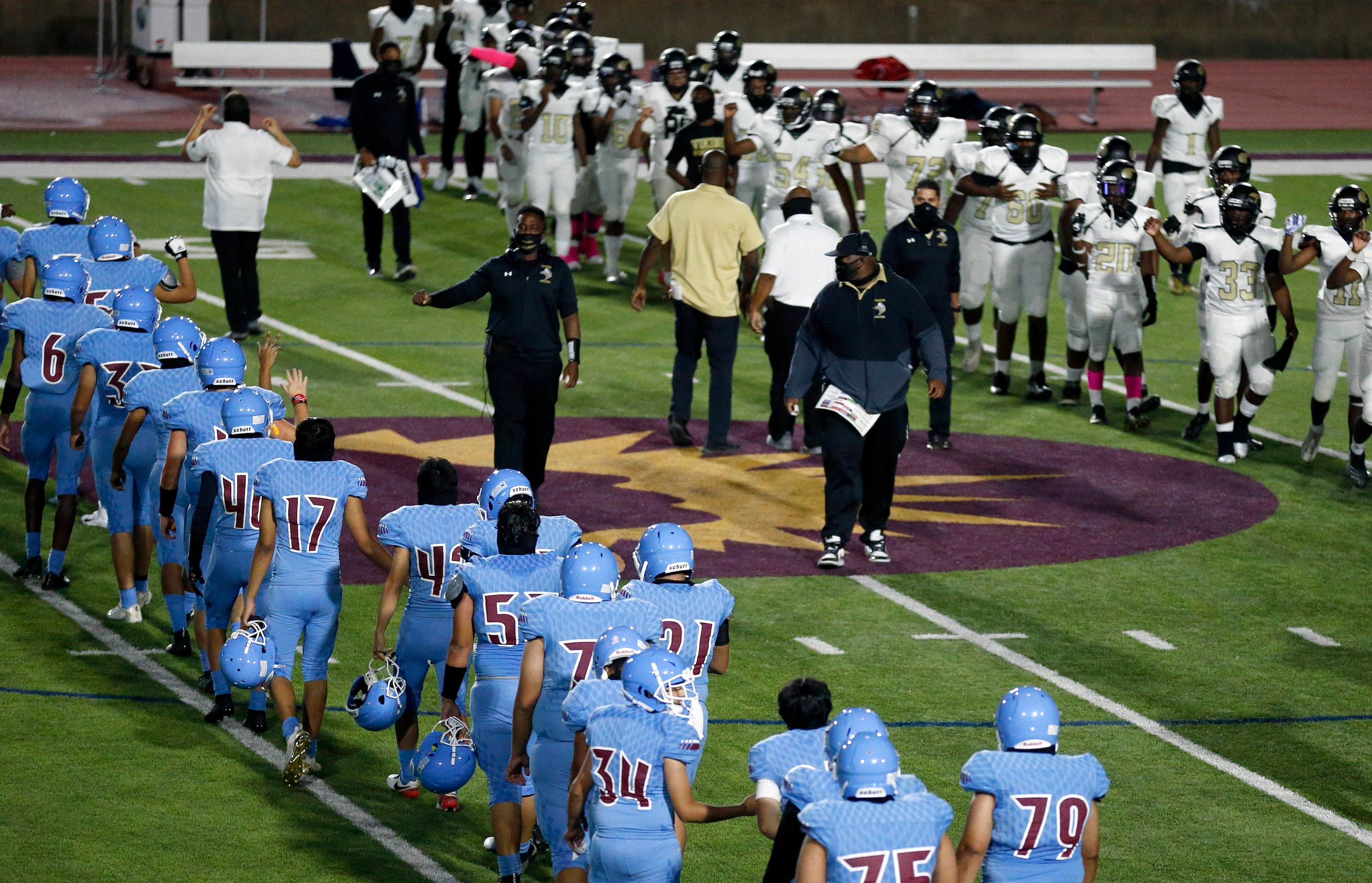 Lined up on the 45 yard lines, Thomas Jefferson football players (left) and Pinkston...