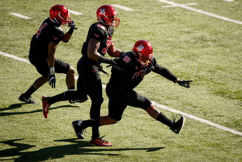 SMU defensive lineman Demerick Gary (10) celebrates with defensive lineman Delontae Scott...