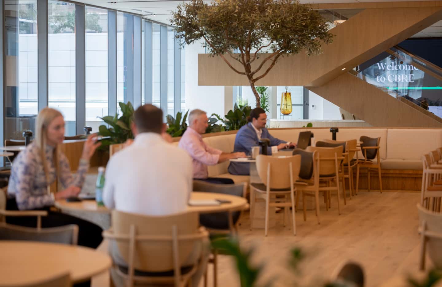 Visitors to CBRE's new global headquarters are met by a reception desk and the company's new...