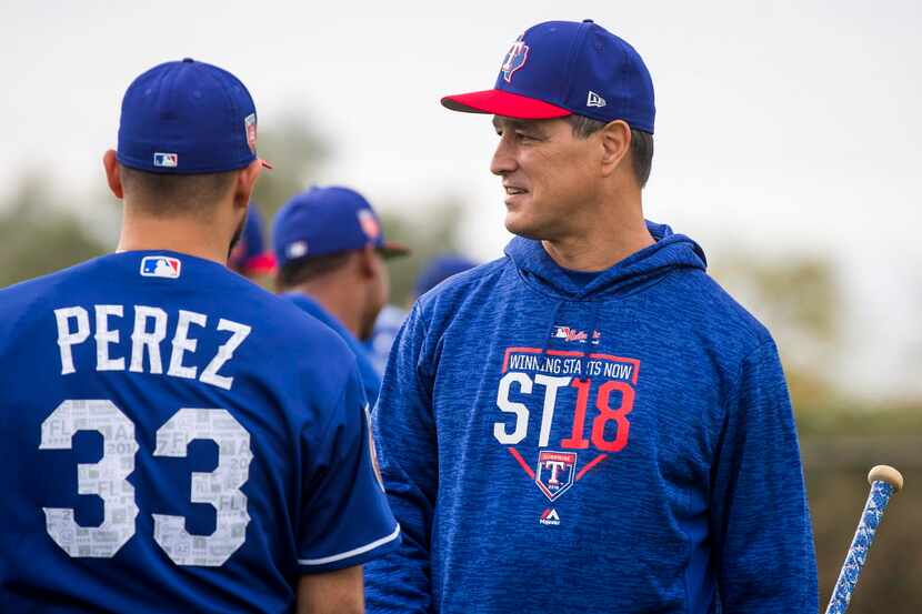 Texas Rangers bench coach Don Wakamatsu talks with pitcher Martin Perez during a spring...