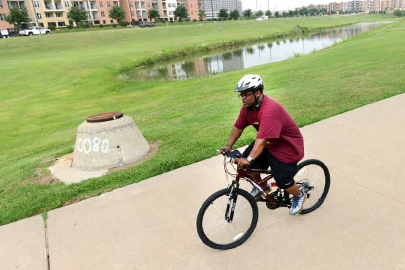 Andre Herron rides his bike along the trails in Irving's Las Colinas. A new study found that...