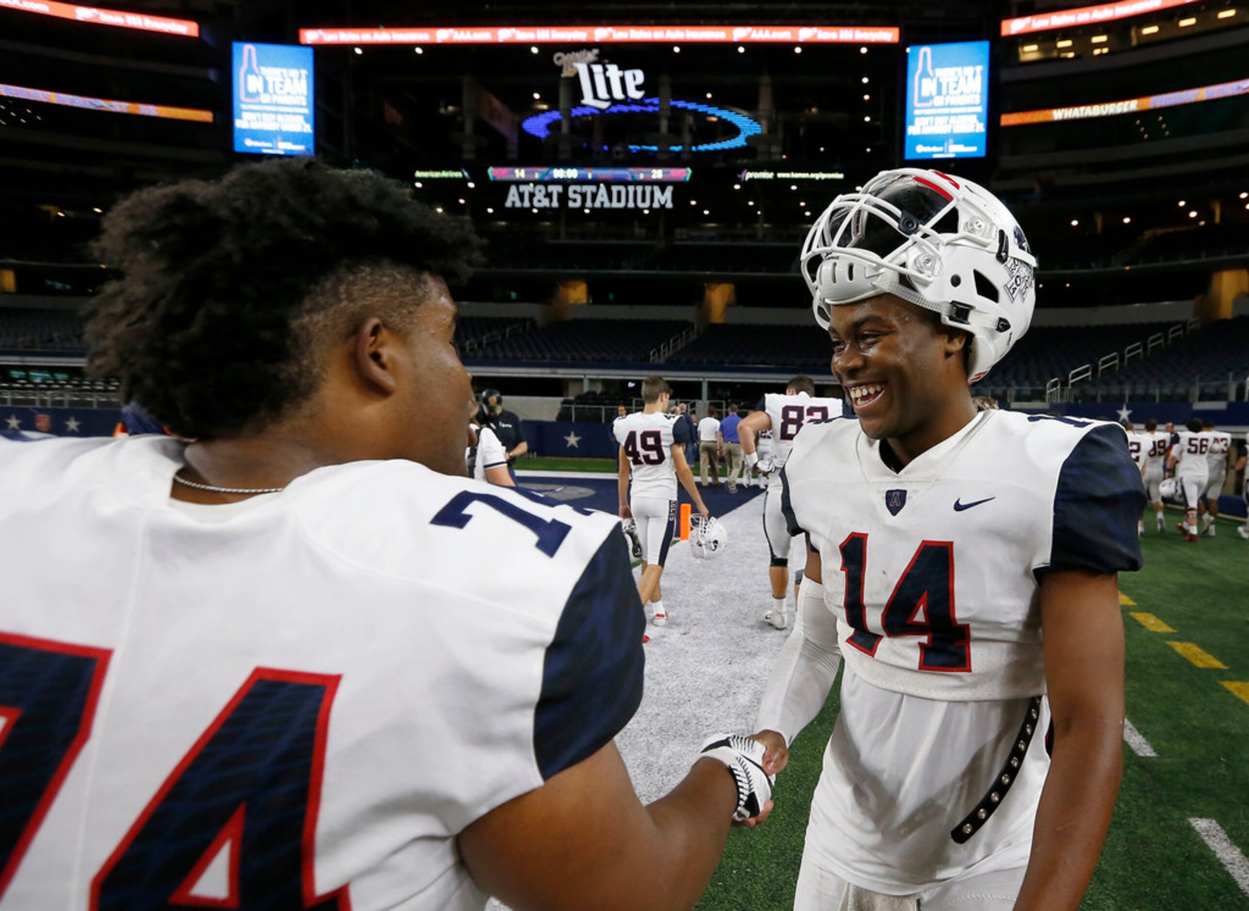 Allen's Grant Tisdale (14) and Willis Williams (74) celebrate a 28-14 win over South Grand...