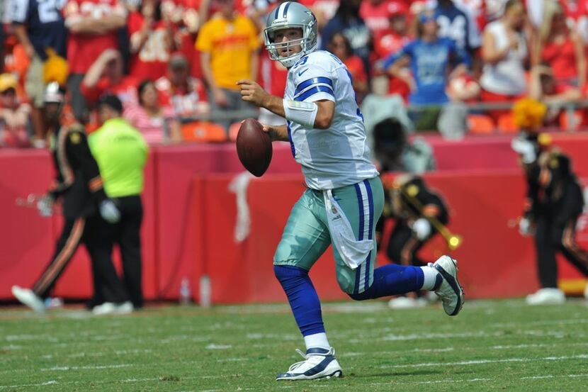 KANSAS CITY, MO - SEPTEMBER 15: Quarterback Tony Romo #9 of the Dallas Cowboys rolls to the...