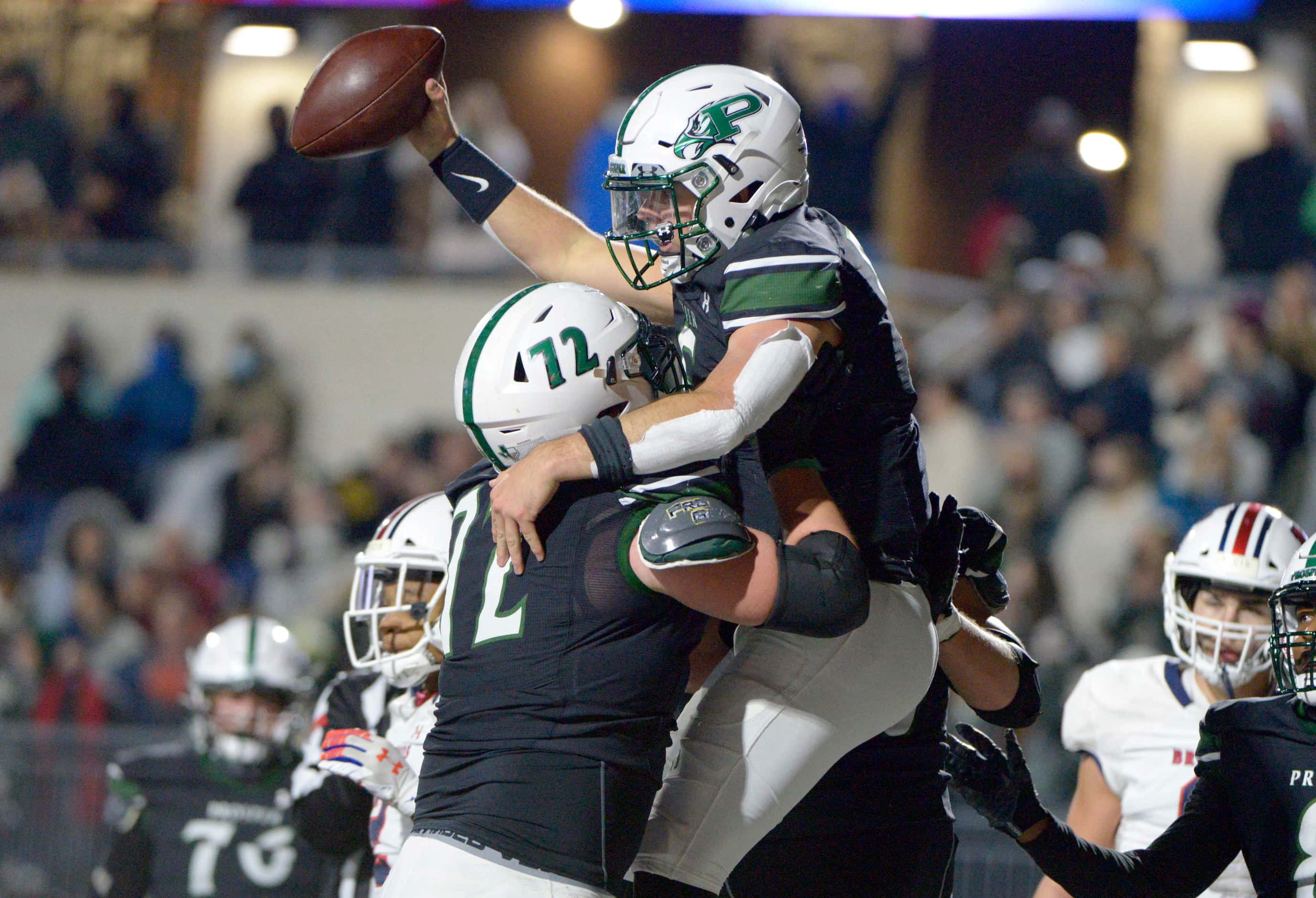Prosper’s Jackson Berry (5) celebrates his touchdown with Troy Stansell (72) in the second...