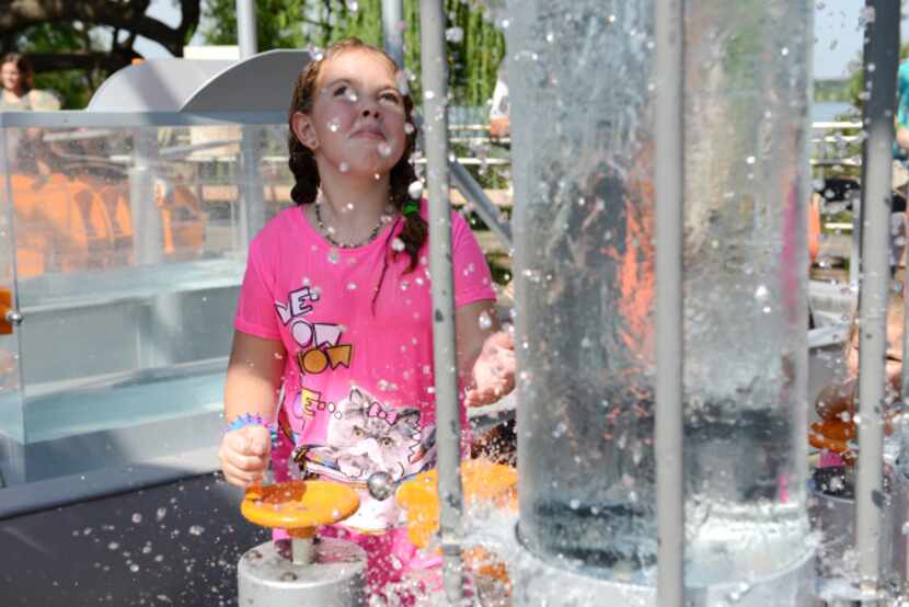 Julia Rose Snyder, 7, cools off in the water power section of Rory Meyers Children's...