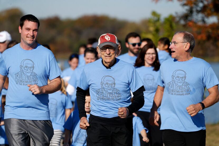 Orville Rogers (middle), who is turning 100-years-old, runs with his family including his...