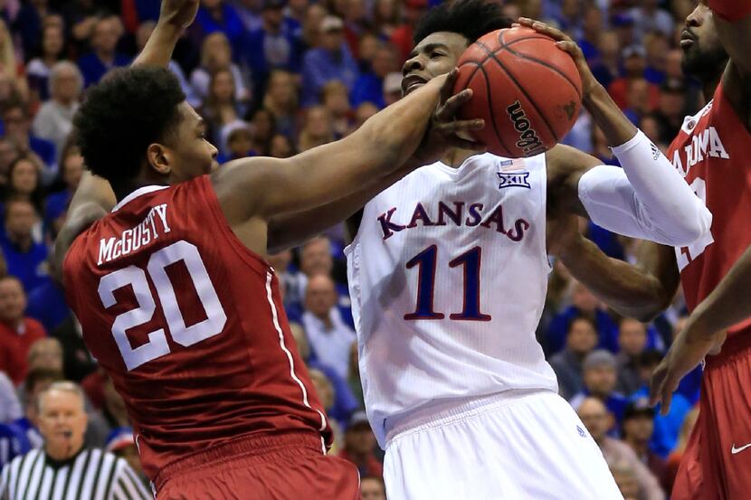 Kansas guard Josh Jackson (11) is fouled by Oklahoma guard Kameron McGusty (20) during the...