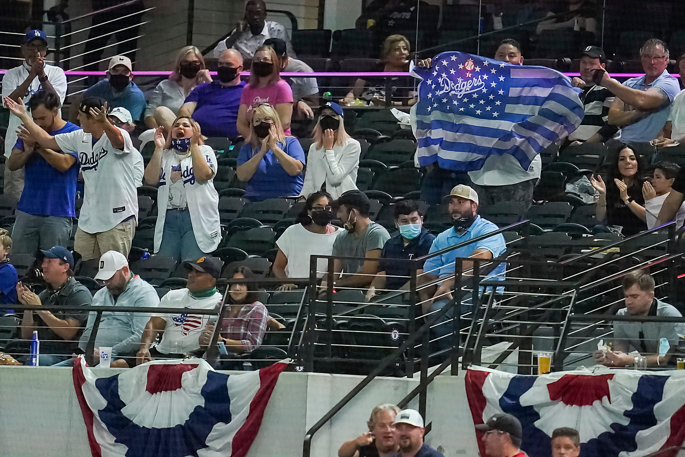 Los Angeles Dodgers fans cheer their team during the second inning against the Atlanta...