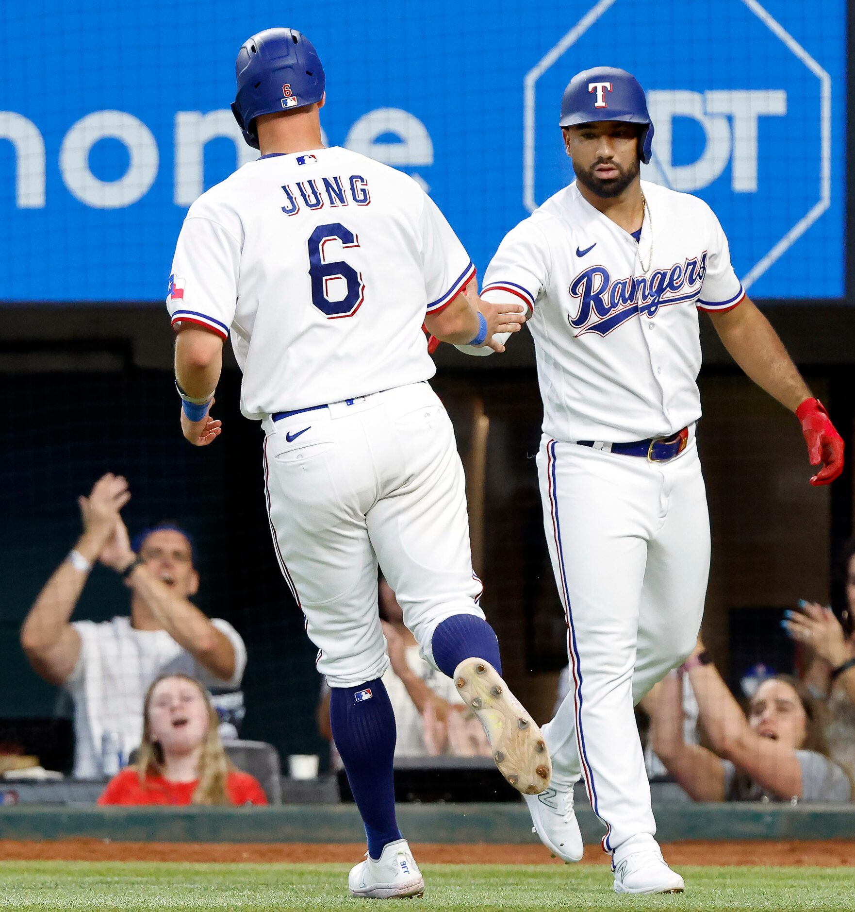 Texas Rangers Josh Jung (6) is congratulated by teammate Ezequiel Duran (20) after he scored...