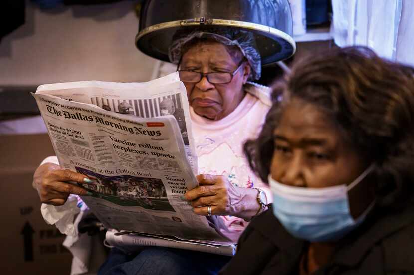 Client Vera Harris reads the newspaper as she sits under a hair dryer at the beauty shop of...