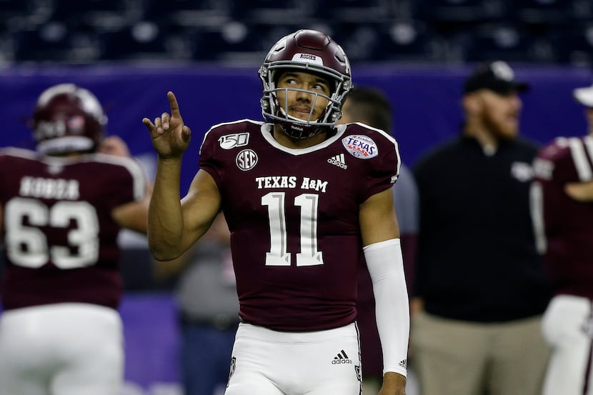 HOUSTON, TEXAS - DECEMBER 27: Kellen Mond #11 of the Texas A&M Aggies warms up before...