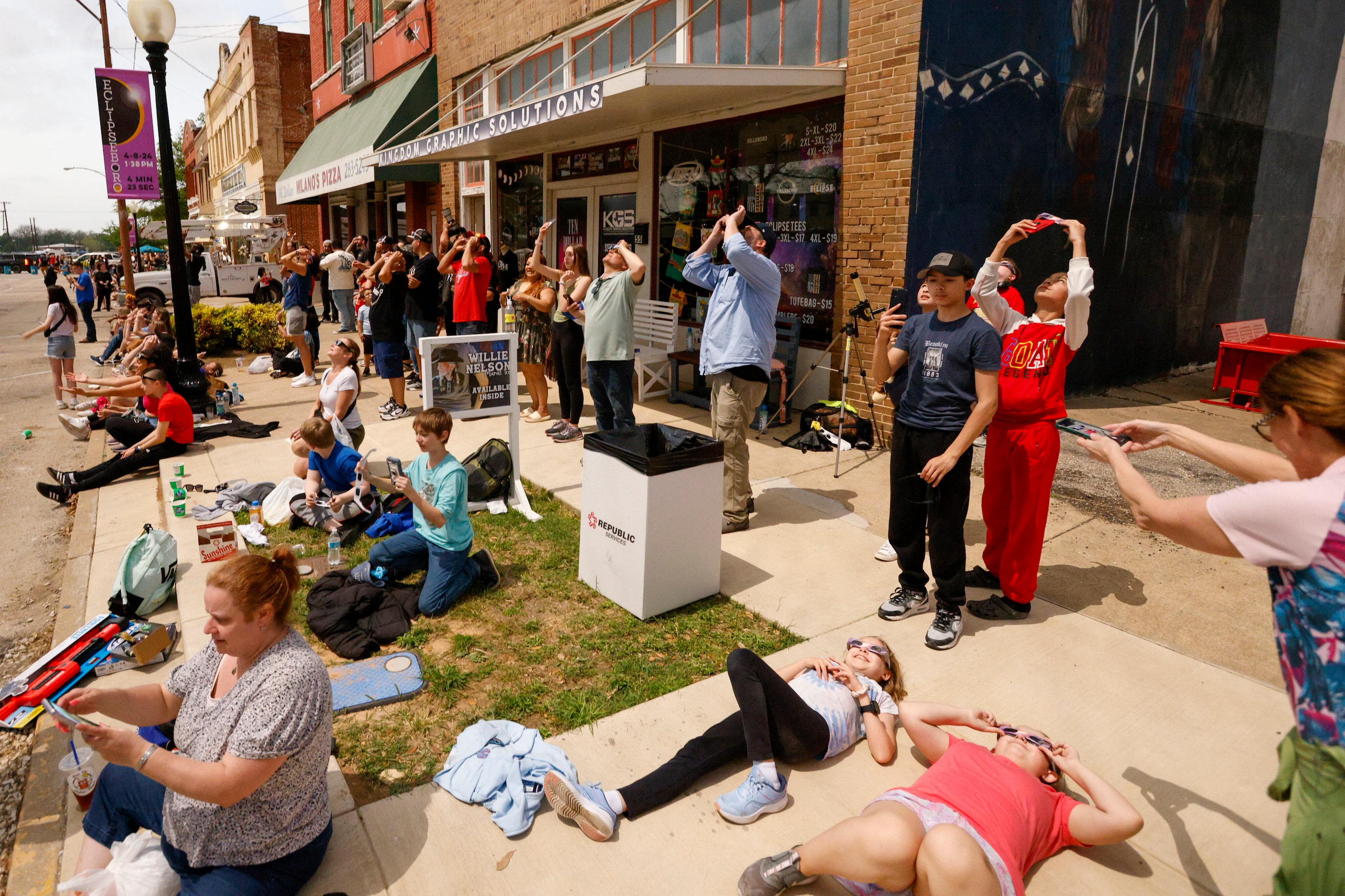 People look to the sky moments after a total solar eclipse, Monday, April 8, 2024, in...