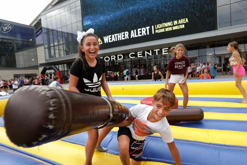 Children played during a Camp Gladiator stadium takeover event at The Star in Frisco on Aug....