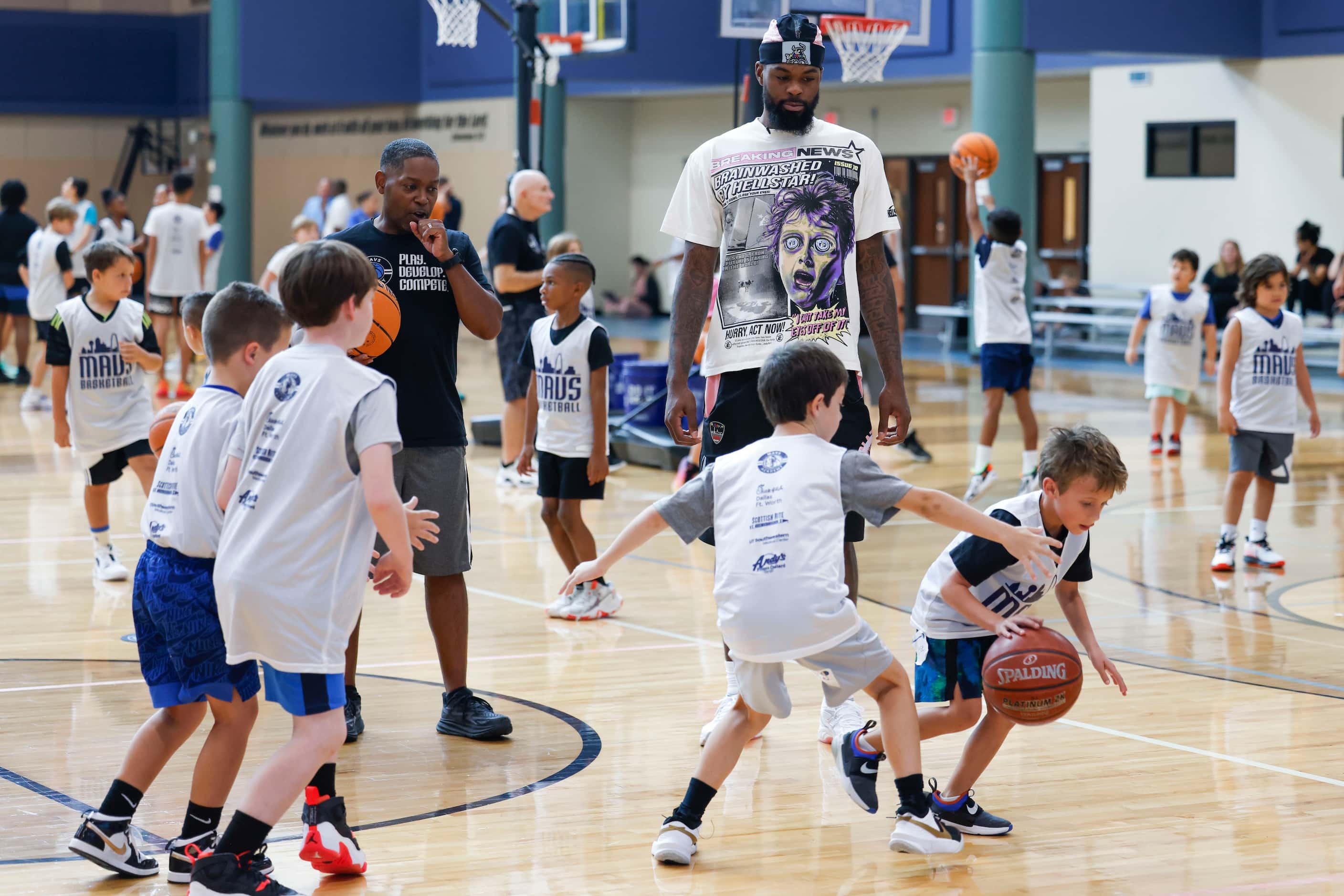 Dallas Mavericks’ Naji Marshall watches young basketball ball campers during a Hoop Camp,...