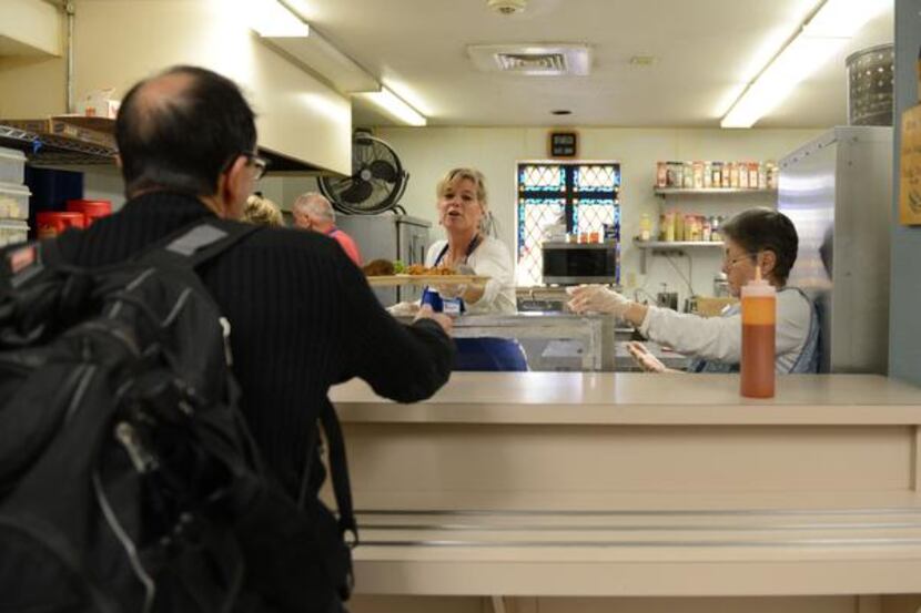 
Bridget Eckert serves a meal to a client at Our Daily Bread. The charity is a partnership...