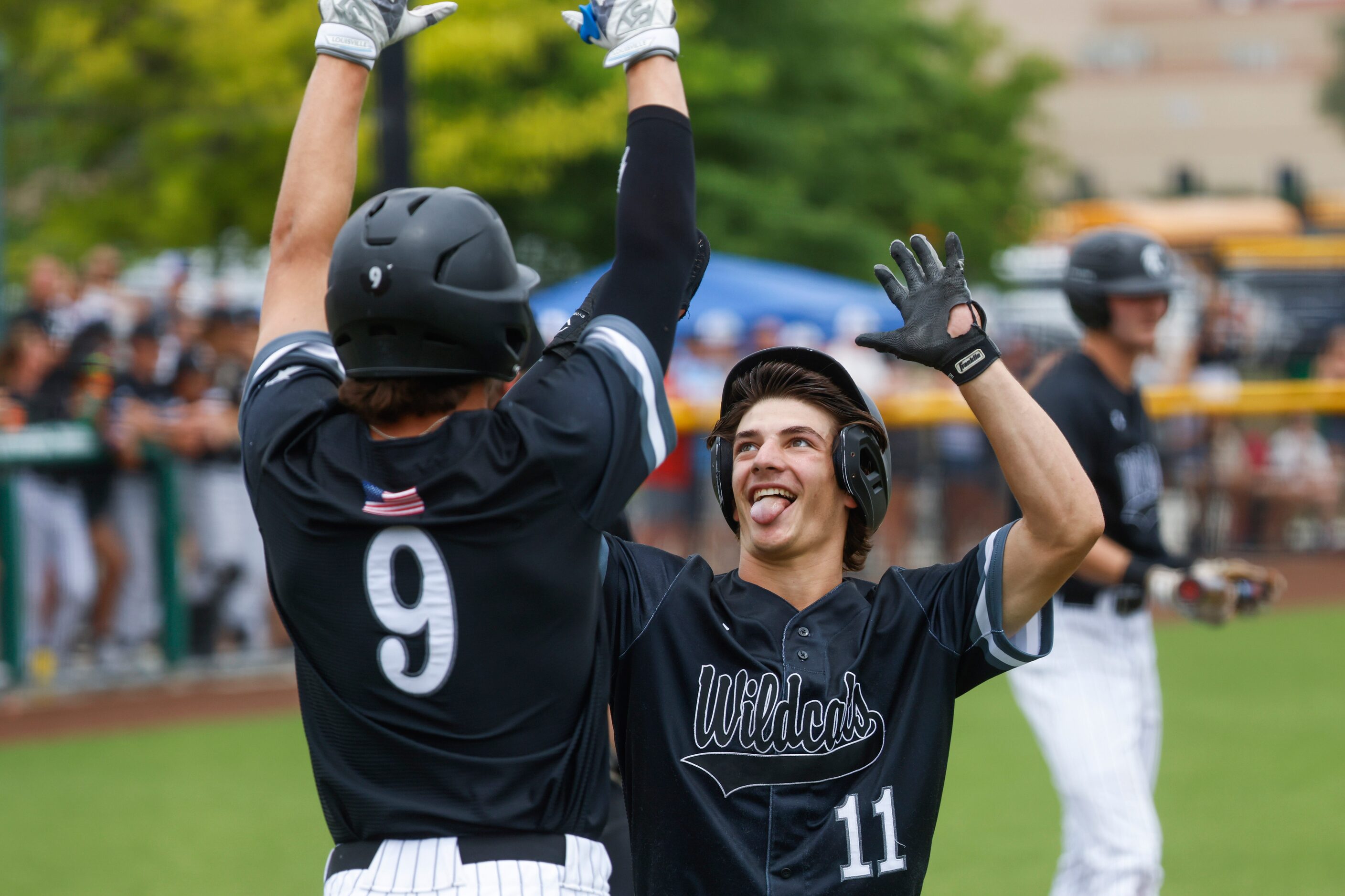 Denton Guyer’s Caleb Cowan (left) and Seth Johnston high fives after a homer during a...