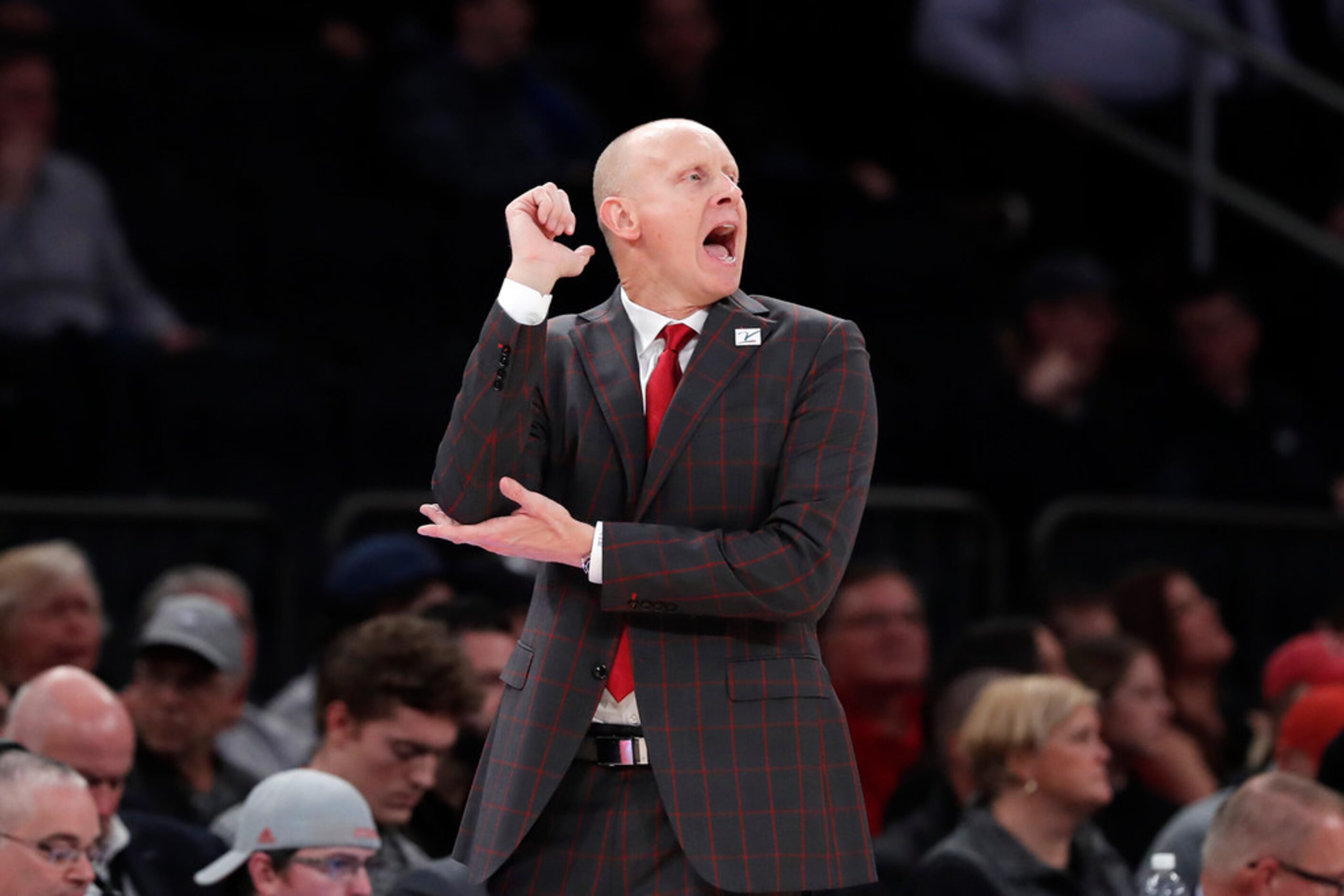 Louisville head coach Chris Mack works the sideline during the first half of an NCAA college...