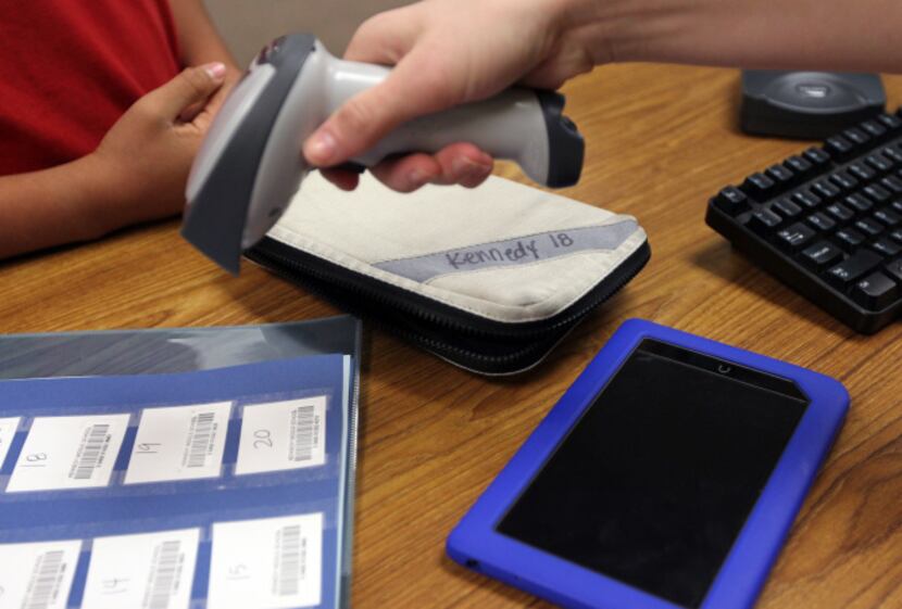 A student at John F. Kennedy Middle School in Grand Prairie ISD returns a Nook e-reader.