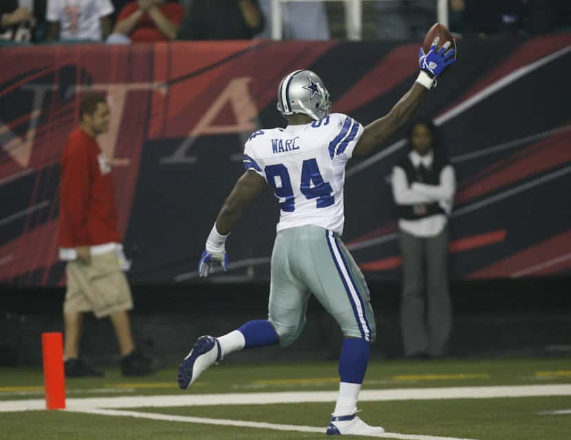 Cowboys linebacker DeMarcus Ware (94) runs an interception back for a touchdown during first...