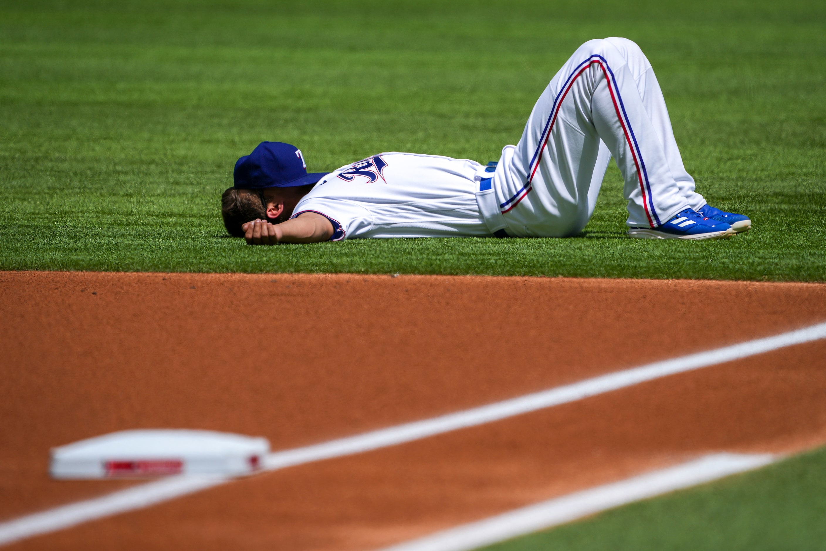 Texas Rangers shortstop Corey Seager stretches before the Rangers home opener against the...