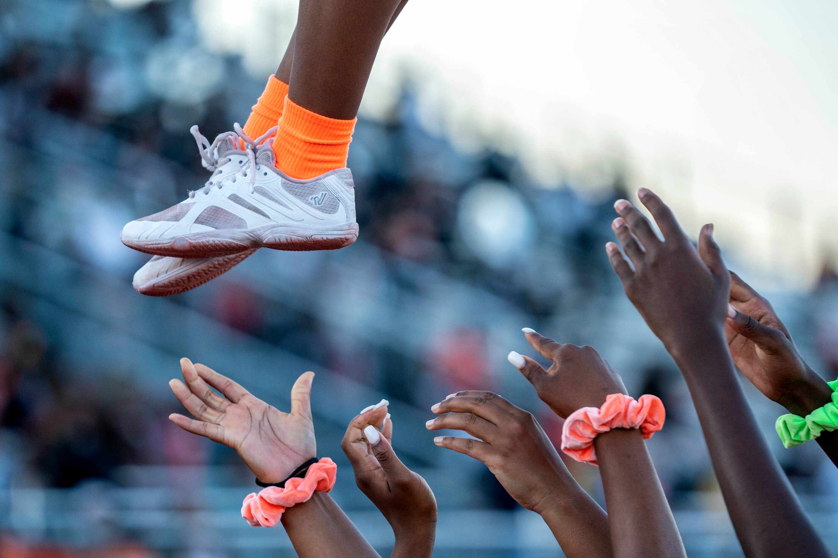 A Lancaster cheerleader is tossed into the air before a high school football game against...