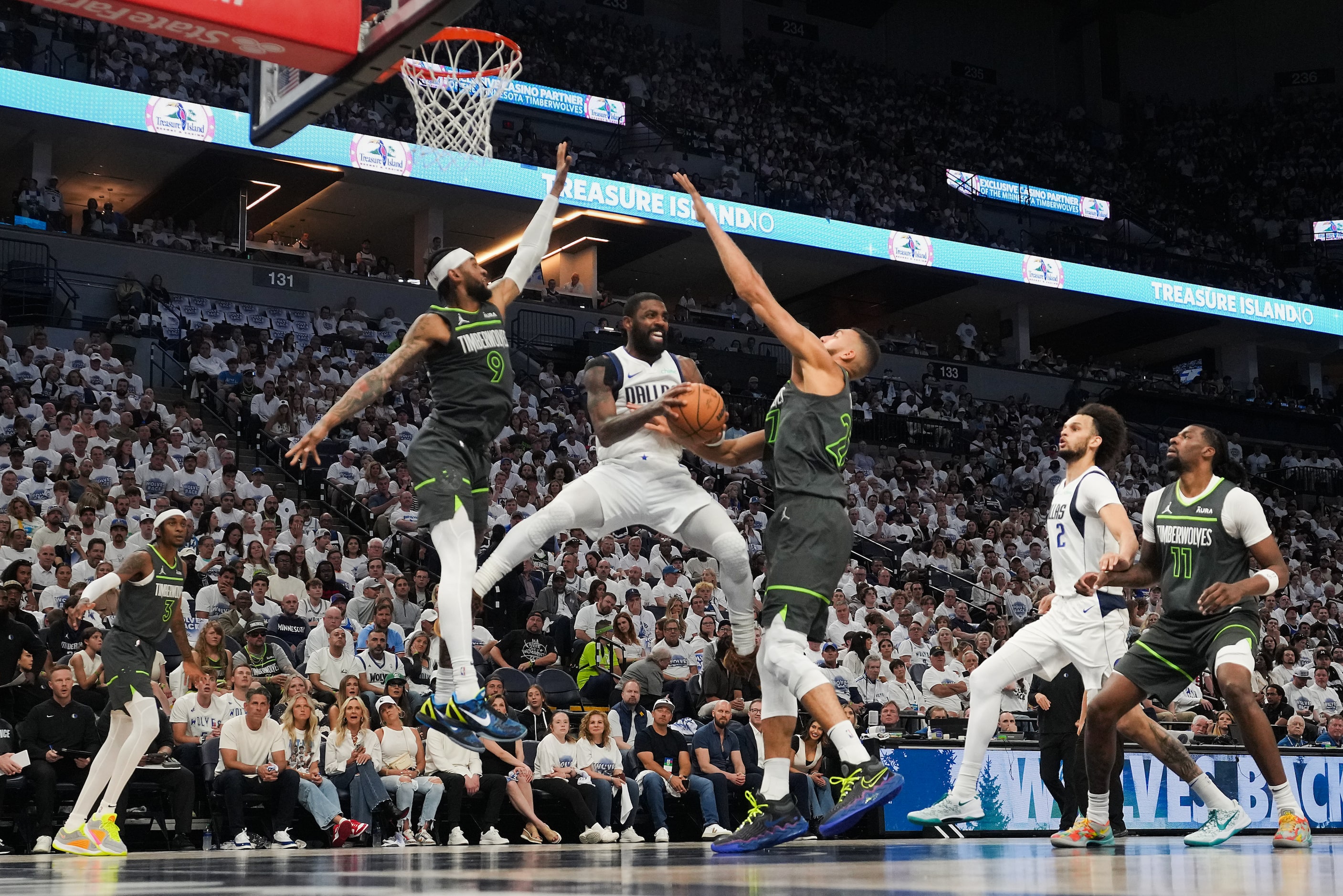 Dallas Mavericks guard Kyrie Irving (11) passes around Minnesota Timberwolves center Rudy...