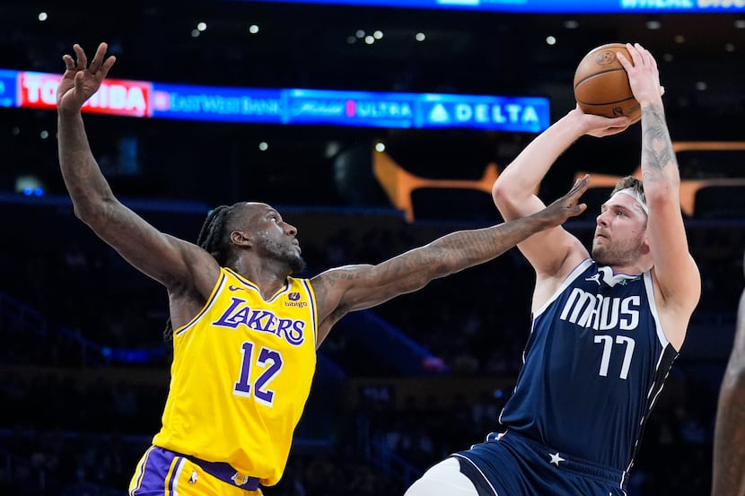 Dallas Mavericks guard Luka Doncic (77) shoots over Los Angeles Lakers forward Taurean...