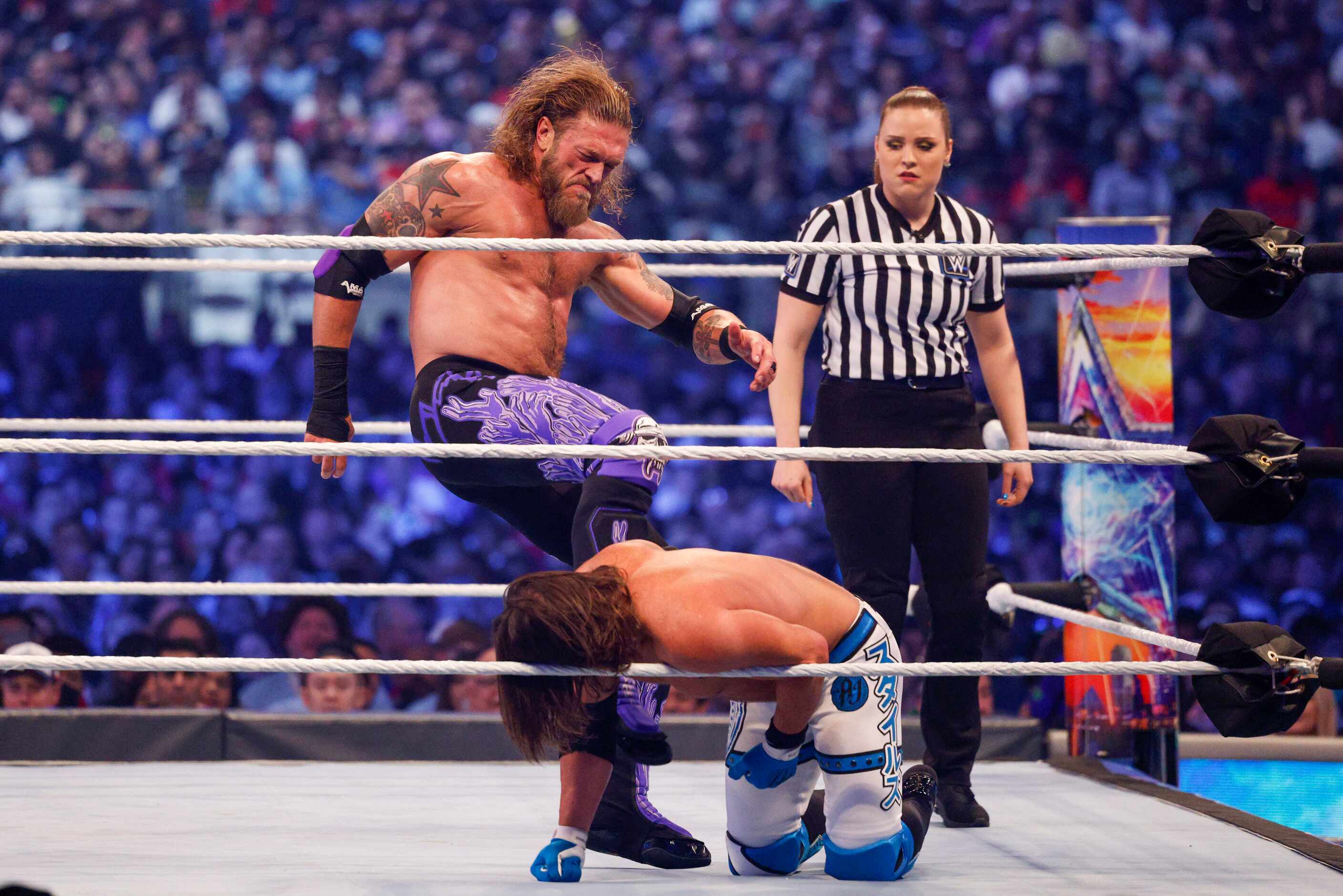 Edge (left) kicks AJ Styles during a match at WrestleMania Sunday at AT&T Stadium in...