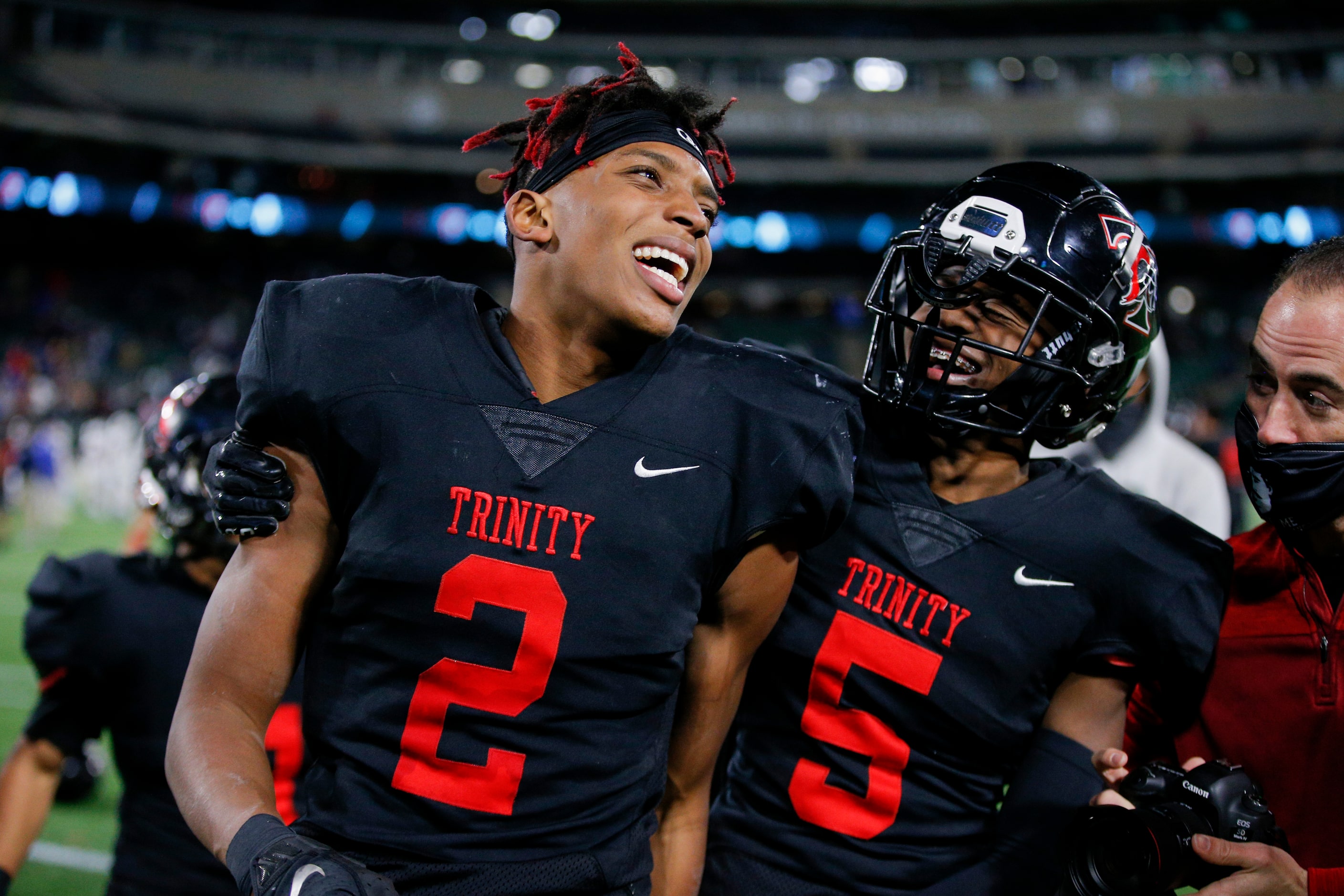 Euless Trinity junior running back Ollie Gordon (2) and junior defensive back Jayveus Lyons...