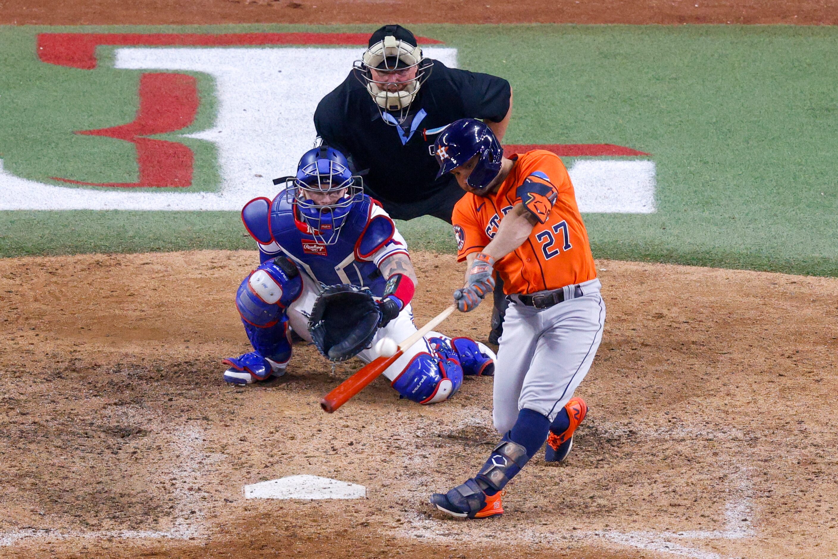 Houston Astros second baseman Jose Altuve hits a three-run, go-ahead home run off of Texas...