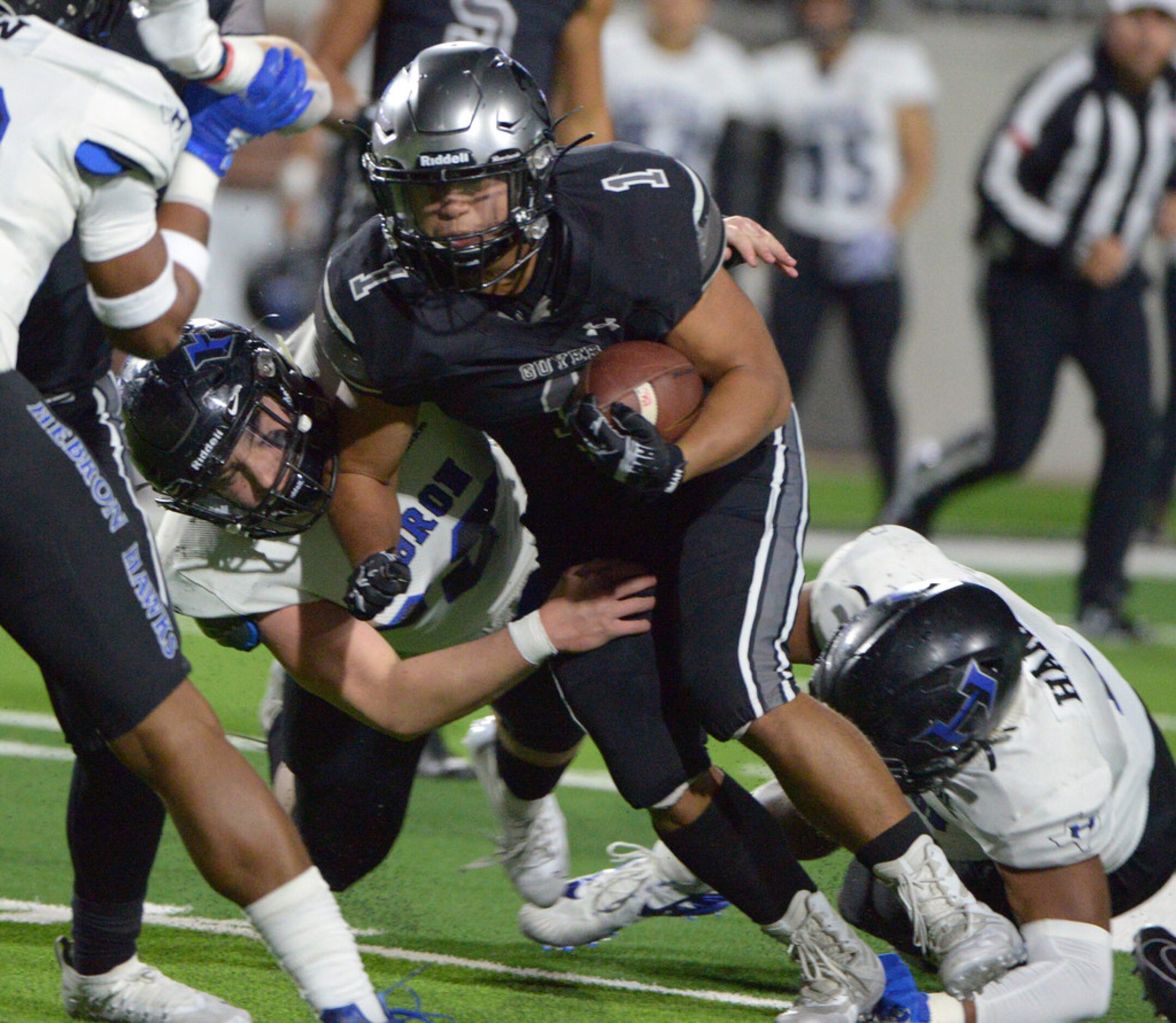 Guyer's Kaedric Cobbs runs through the Hebron defense in the first half of a Class 6A...