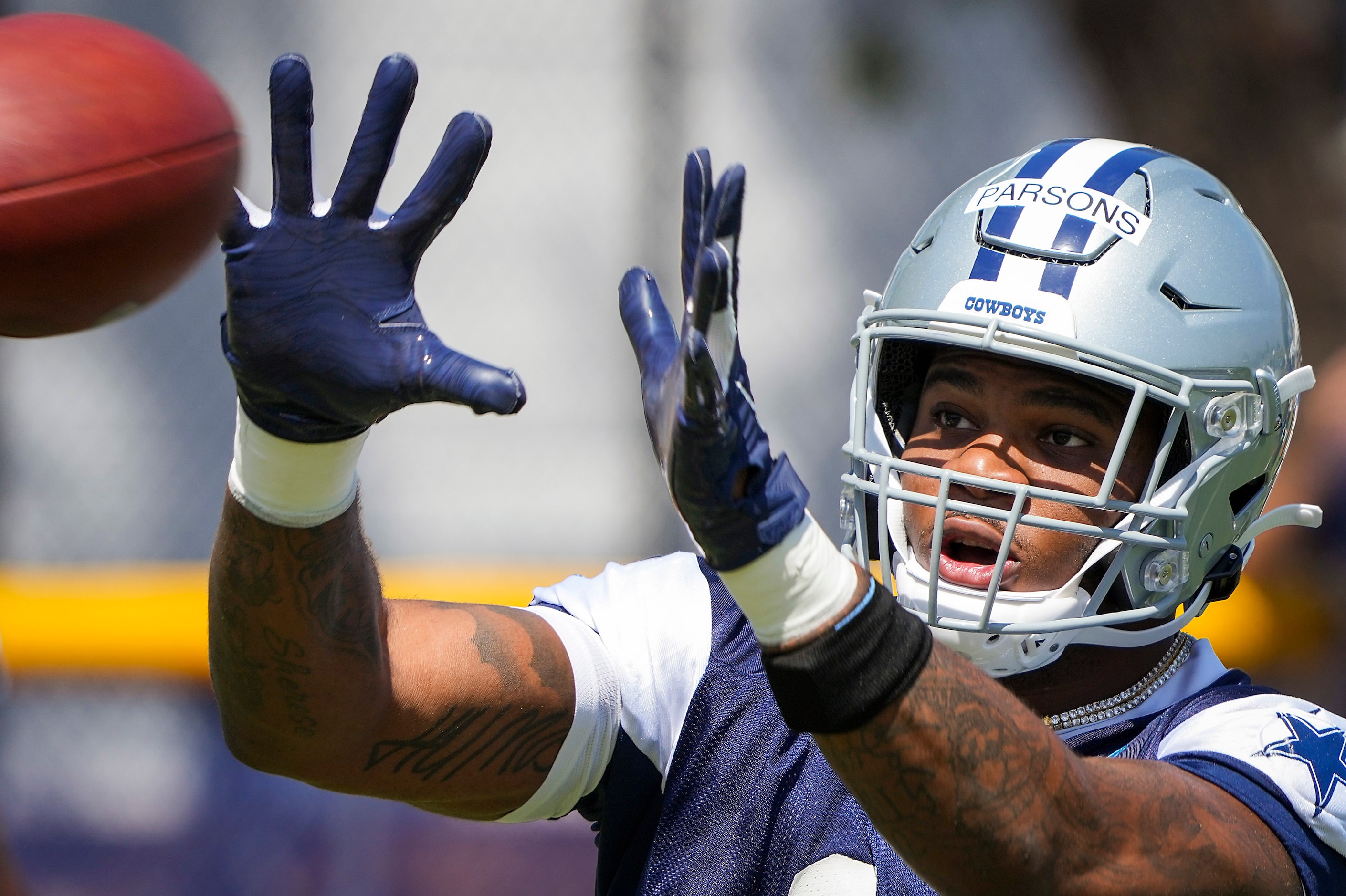 Dallas Cowboys linebacker Micah Parsons (11) reaches for a pass during the first practice of...