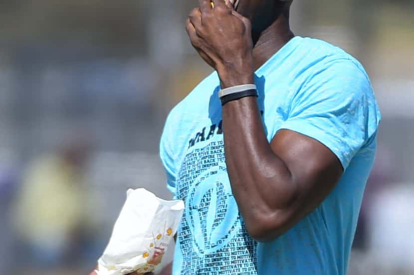 Former Dallas Cowboys player Terrell Owens eats popcorn during their afternoon practice in...