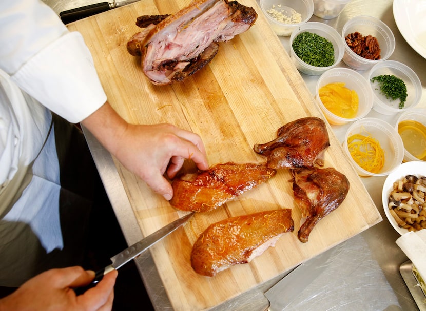 Executive chef Sebastien Archambault carves a roasted duck a l'orange 