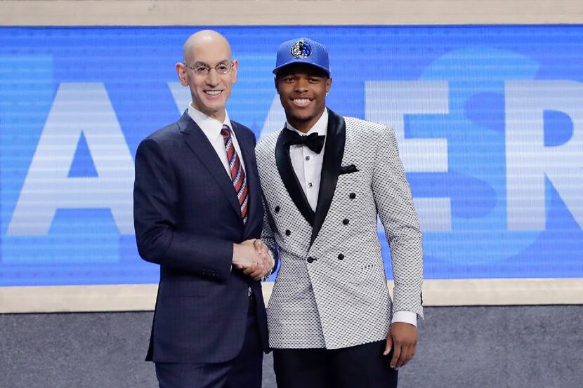 Dennis Smith Jr., right, poses for photos with NBA Commissioner Adam Silver after being...