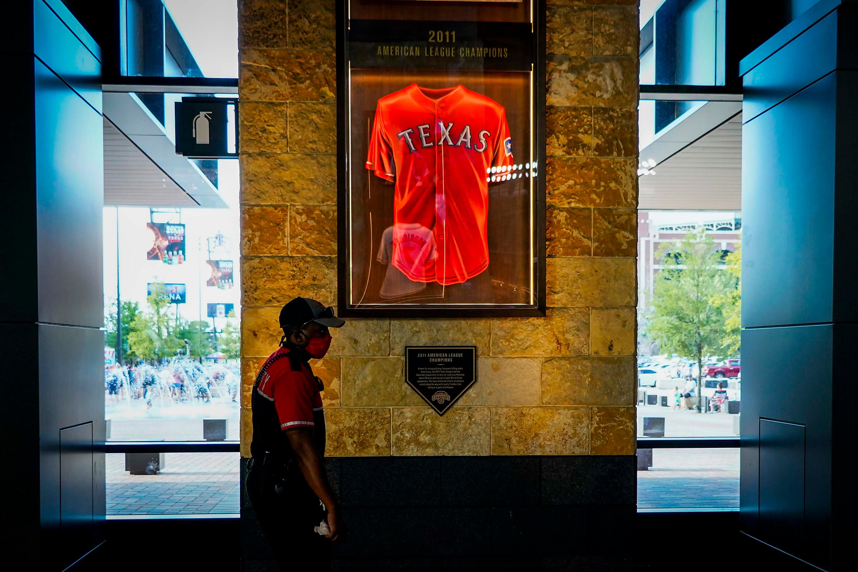 A security guard passes a display recognizing the Texas Rangers 2011 American League...