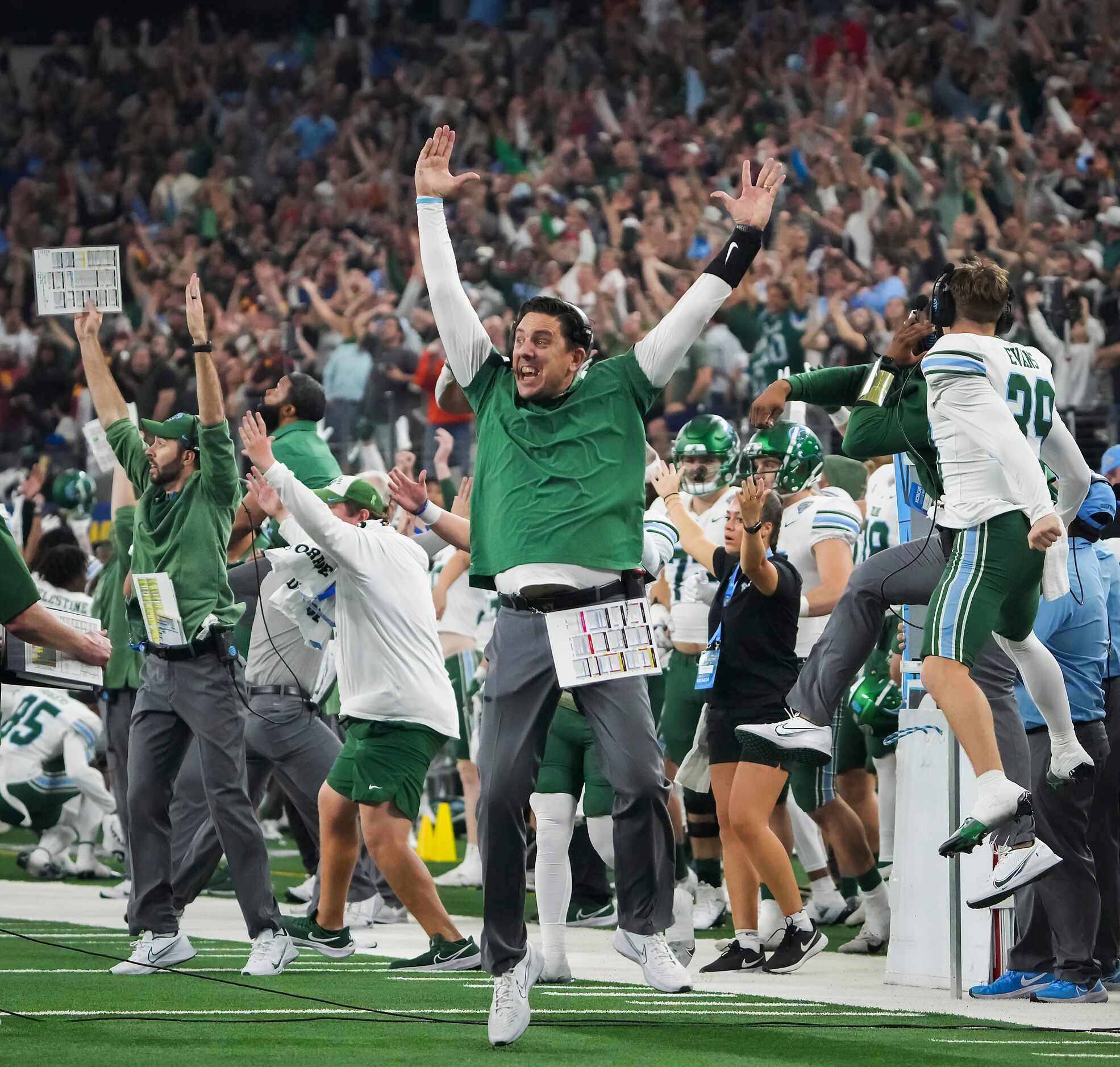 The Tulane bench erupts after tight end Alex Bauman scored on a 6-yard touchdown pass with...