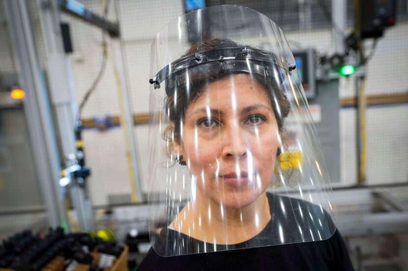 Face coverings are not required for everyone at Flex-N-Gate, but about half the workers wear...