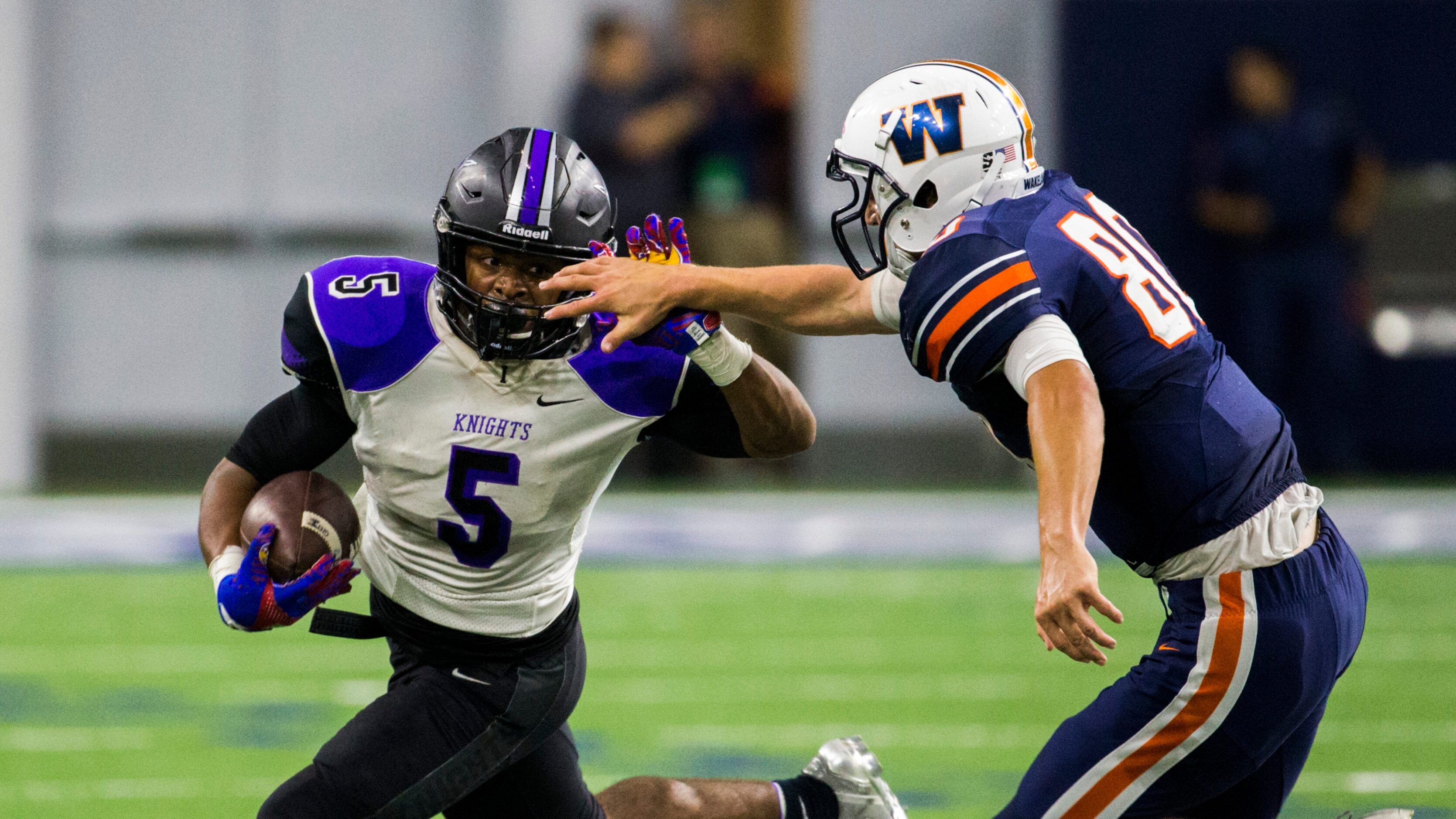 Frisco Independence running back Dom Williams (5) pushes away the hand of Frisco Wakeland...