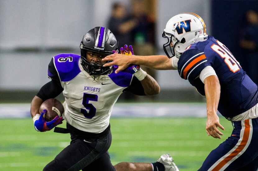 Frisco Independence running back Dom Williams (5) pushes away the hand of Frisco Wakeland...