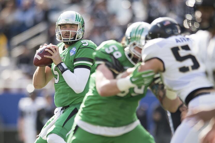 DALLAS, TX - DECEMBER 27:  Alec Morris #5 of the North Texas Mean Green drops back to pass...