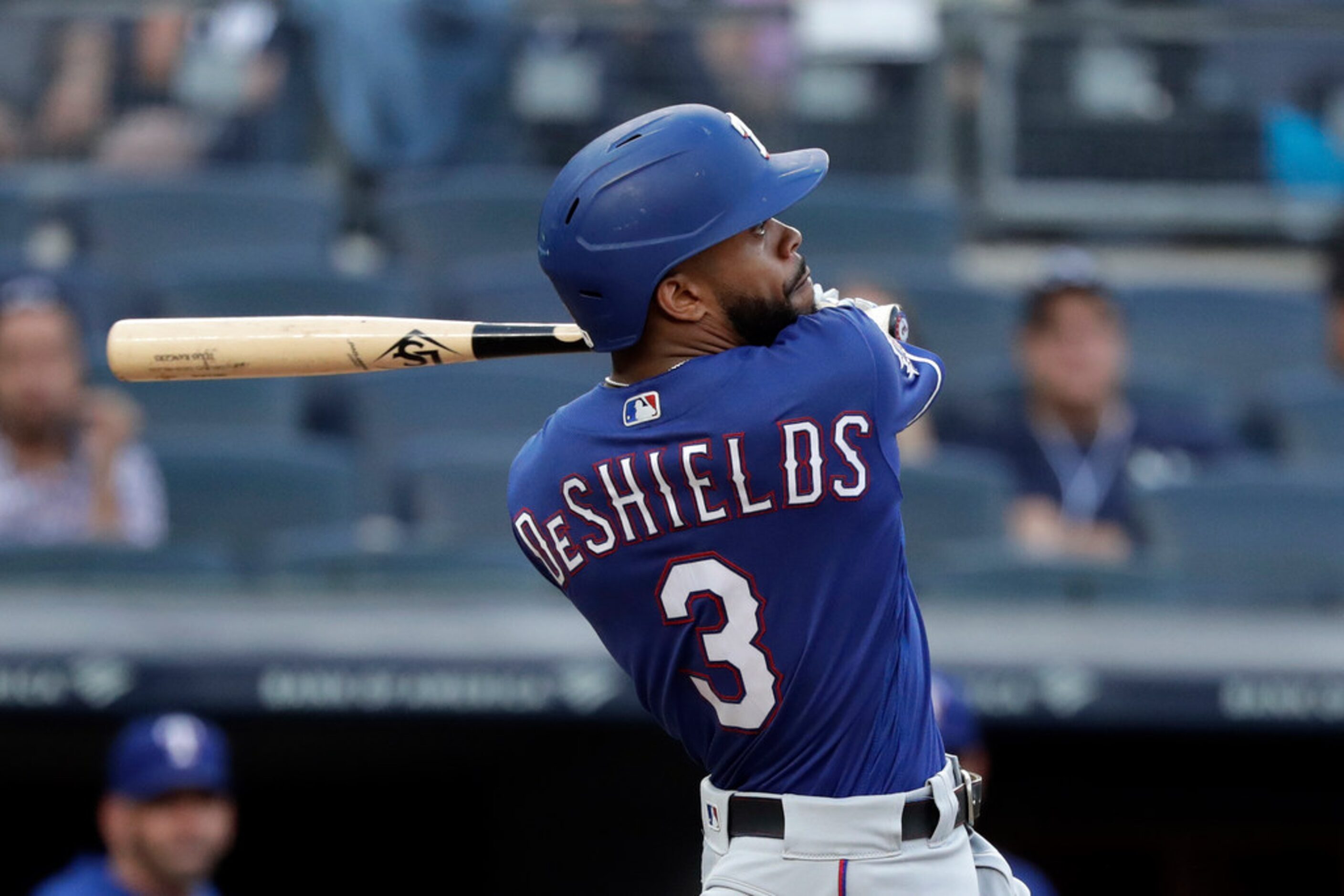 Texas Rangers' Delino DeShields hits a three-run home run during the eighth inning of a...