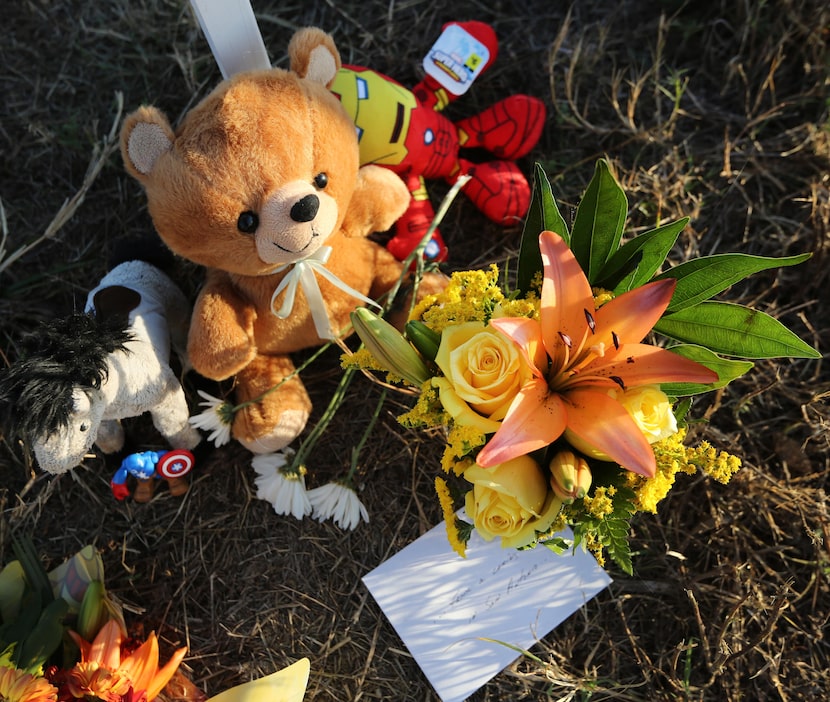 Remembrances left near the group of 26 crosses sit in the afternoon sun in Sutherland...