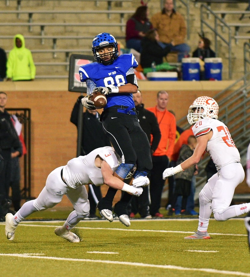 Krum junior wide receiver Justus Martinez (88) is hit coming down by Celina senior...