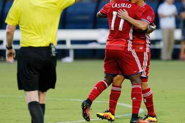 FC Dallas forward Fabian Castillo (11) is embraced by FC Dallas midfielder Mauro Diaz (10)...